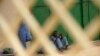 FILE - Prisoners sit against a wall in a prison in Hargesia, Somaliland, March 8, 2012. At least seven journalists were detained April 13, 2022, as they reported on a prison disturbance in the capital.