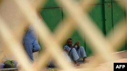 FILE - Prisoners sit against a wall in a prison in Hargesia, Somaliland, March 8, 2012. At least seven journalists were detained April 13, 2022, as they reported on a prison disturbance in the capital.