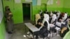 FILE - Girls attend a class at their school in Kabul, March 23, 2022. The Taliban prohibition on girls' education shows ultra-conservatives retain control of the Islamist group and exposes a power struggle putting at risk crucial aid for Afghanistan's desperate population.
