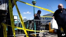 A police officer stands watch at the entrance of 36th Street Station after multiple people were shot on a subway train, April 12, 2022, in the Brooklyn borough of New York.