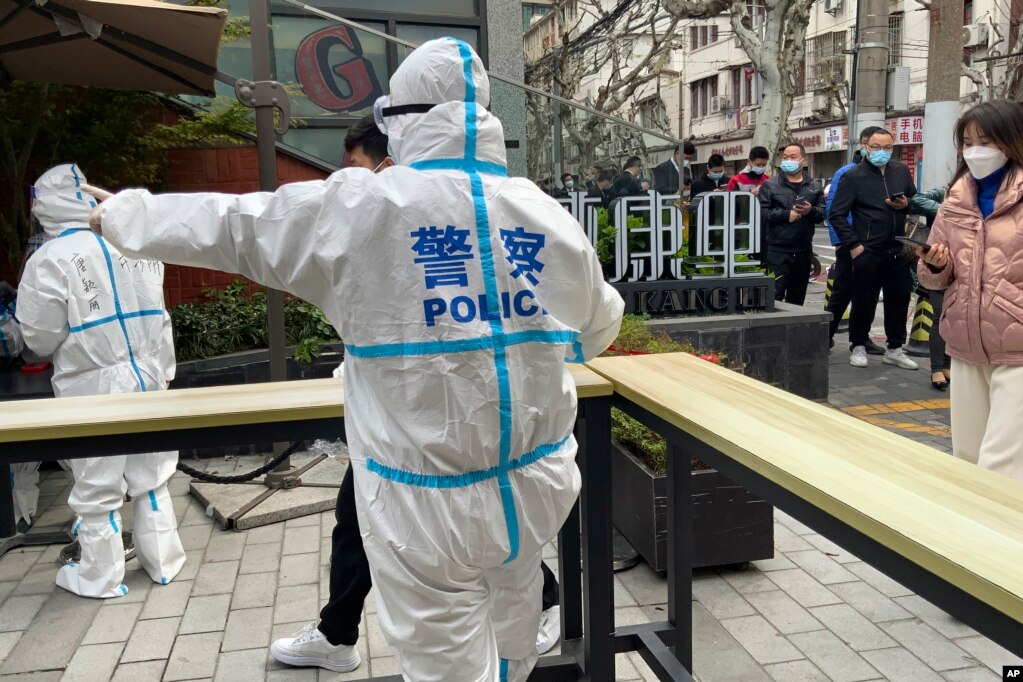 2022年4月1日，上海静安区的警察指挥居民排队等待核酸检测。(photo:VOA)