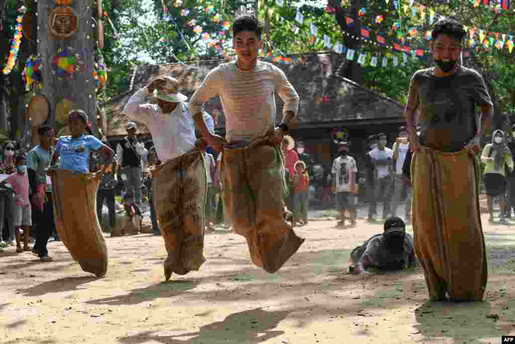 People compete in a sack race during Khmer New Year celebrations at Chau Say Tevoda temple in Siem Reap province in Cambodia.