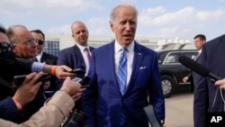 President Joe Biden speaks to reporters before boarding Air Force One at Des Moines International Airport, in Des Moines Iowa, Tuesday, April 12, 2022, en route to Washington.