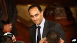 FILE - Gamal Mubarak, center, son of Egyptian President Hosni Mubarak, talks to guests prior to the speech of U.S. President Barack Obama at Cairo University in Cairo, Egypt, June 4, 2009.