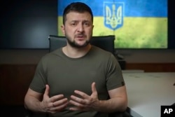 In this image from video provided by the Ukrainian Presidential Press Office, Ukrainian President Volodymyr Zelenskyy speaks from Kyiv, Ukraine, April 15, 2022. Zelenskyy said his country was seeking to break Russia's siege of Mariupol.