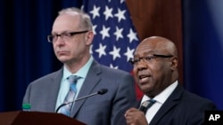 Dr. John F. Huth, left, DIA Defense Intelligence Officer for Space and Counterspace and Kevin Ryder, DIA Senior Defense Intelligence Analyst for Space and Counterspace, participate in a briefing at the Pentagon in Washington, Tuesday, April 12, 2022.