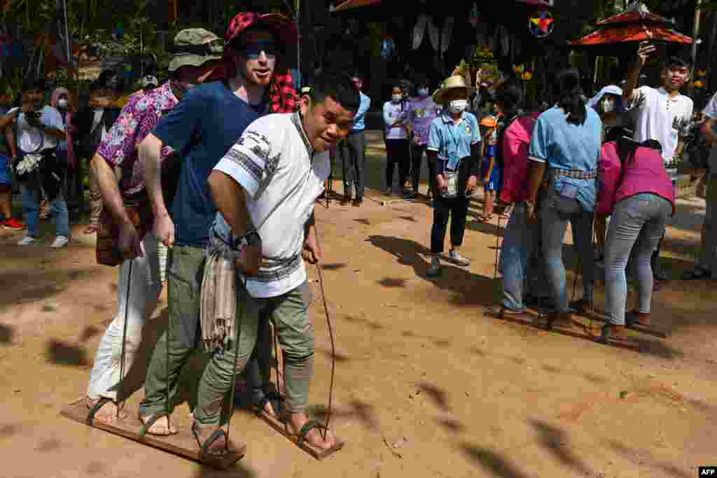 People take part in a game during Khmer New Year celebrations at Chau Say Tevoda temple in Siem Reap province on April 14, 2022.