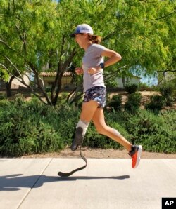 In this image provided by Edwin Broersma, marathoner Jacky Hunt-Broersma runs her 82nd consecutive marathon on April 8, 2022, near her home in Gilbert, Az. (Edwin Broersma photo via AP)