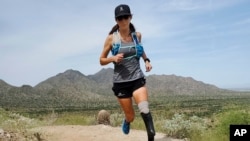 In this image provided by Edwin Broersma, marathoner Jacky Hunt-Broersma trains on Aug. 28, 2021 at San Tan Mountain Regional Park, in San Tan Valley, Az. (Edwin Broersma via AP)