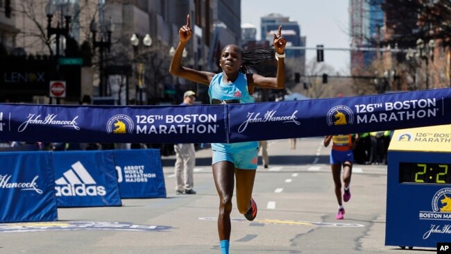 Peres Jepchirchir of Kenya crosses the finish line to win the women's division of the Boston Marathon, April 18, 2022.