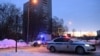 FILE - A police van with escort vehicle is seen driving down a street in Moscow, Russia, Feb. 20, 2021. 