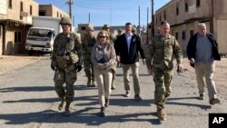 FILE: Brigadier General Curt Taylor, commander of the National Training Center, walks with Army Secretary Christine Wormuth to watch soldiers train using lessons from the war on Ukraine at the National Training Center at Fort Irwin, Calif., April 12, 2022.