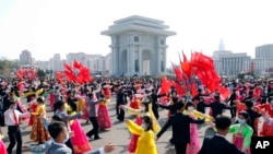 Students and youth of Pyongyang participate in a dancing party to commemorate the 10th anniversary of Kim Jong Un's election as the top party and state leader at the plaza of Arch of Triumph in Pyongyang, North Korea, April 11, 2022. 