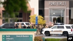Members of law enforcement gather outside Columbiana Centre mall in Columbia, South Carolina, following a shooting, April 16, 2022. 