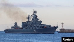 FILE - The Russian navy's guided missile cruiser Moskva sails back into a harbor after tracking NATO warships in the Black Sea, in the port of Sevastopol, Crimea, Nov. 16, 2021.