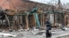 A man walks past a destroyed building in the southern port city of Mariupol, Ukraine, during Russia's invasion of Ukraine, April 14, 2022.