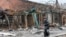A man walks past a destroyed building in the southern port city of Mariupol, Ukraine, during Russia's invasion of Ukraine, April 14, 2022.