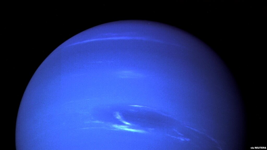 The "Great Dark Spot", a storm in the atmosphere and the bright, light-blue smudge of clouds that accompanies the storm is seen on the planet Neptune, taken by the NASA spacecraft Voyager 2 less than five days before its closest approach of the planet on 