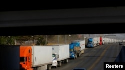 Trucks wait to cross into the United States as Mexican truck drivers block the Zaragoza-Ysleta International Bridge to protest truck inspections imposed by Texas Governor Greg Abbott, in Ciudad Juarez, Mexico on April 12, 2022.