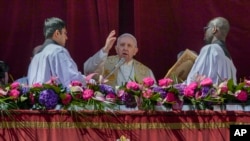 Pope Francis delivers the traditional 'Urbi et Orbi' (To the city and to the world) blessing at the end of the Catholic Easter Sunday Mass in St. Peter's Square at the Vatican, April 17, 2022.