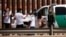 FILE - Asylum-seeking migrants are detained by a U.S. Border Patrol agent after crossing the Rio Bravo river, in El Paso, Texas, as seen from Ciudad Juarez, Mexico, April 6, 2022. 