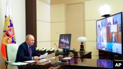 Russian President Vladimir Putin chairs a meeting on the situation in the oil and gas sector via videoconference at the Novo-Ogaryovo residence outside Moscow, \April 14, 2022.