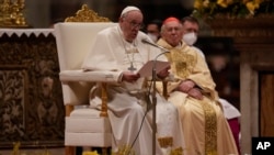Pope Francis reads the homily during an Easter vigil ceremony in St. Peter's Basilica at the Vatican, April 16, 2022.