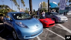 FILE - From left, electric cars from Nissan, Tesla, and Toyota are presented at a news conference in Los Angeles on Dec. 13, 2013. (AP Photo/Nick Ut, File)