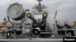 FILE - Russia's coat of arms, the double headed eagle, is seen on covers of the missile cruiser Moskva in the Ukrainian Black Sea port of Sevastopol, Sept. 16, 2008.