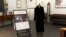 In this image from a video, a black mink fur coat, right, and a signed opera poster belonging to the late U.S. Supreme Court Justice Ruth Bader Ginsburg, are seen at an auction house in Alexandria, Va., on April 11, 2022. The sale will benefit the Washington National Opera.