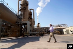 FILE - Derek Benson, chief operating officer of EnergySource Minerals, walks through the Featherstone plant in Calipatria, Calif., where the company is producing geothermal energy and extracting lithium from brine Friday, July 16, 2021. (AP Photo/Marcio Jose San