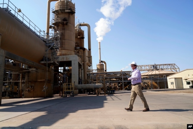 FILE - Derek Benson, chief operating officer of EnergySource Minerals, walks through the Featherstone plant in Calipatria, Calif., where the company is producing geothermal energy and extracting lithium from brine Friday, July 16, 2021. (AP Photo/Marcio Jose San