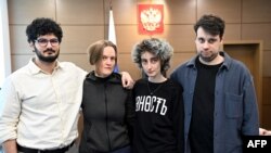 (L-R) Student news site DOXA journalists Armen Aramyan, Natalia Tyshkevich, Alla Gutnikova and Vladimir Metelkin, charged with inciting minors to protest, attend a court hearing in Moscow, March 31, 2022.