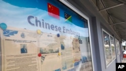FILE - A display case of photos is seen outside the Chinese Embassy in Honiara, Solomon Islands, April 2, 2022.