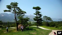Visitors tour the South Korean-owned golf course at Mount Kumgang resort, also known as Diamond Mountain, in North Korea on Sept. 1, 2011.