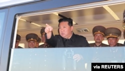 North Korean leader Kim Jong Un gestures as he watches the test-firing of a new type of tactical guided weapon, in this undated photo released April 16, 2022, by North Korea's Korean Central News Agency. 