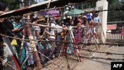 Relatives wait in front of the Insein Prison for the release of prisoners in Yangon on April 17, 2022. 