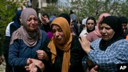 Palestinian Fatima Sbeih, mother of a 21-year-old killed by the Israeli army, cries during his funeral.