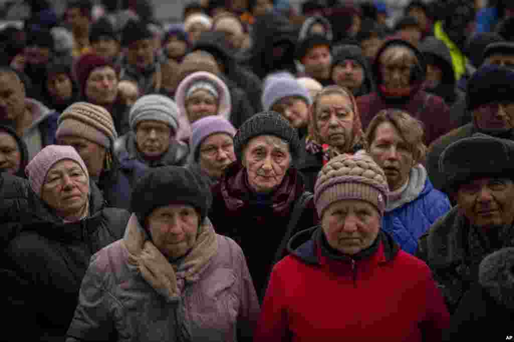 Ukrainians wait for a food distribution organized by the Red Cross in Bucha, on the outskirts of Kyiv.