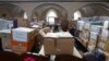 FILE - Members of the Ukrainian orthodox church community pray during their Sunday service in a church also temporarily used to store humanitarian aid ready to be transported to Ukraine, amid Russia's invasion of Ukraine, in Berlin, Germany, April 10, 2022.