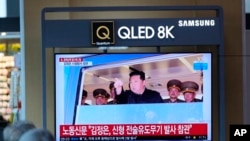 People watch a TV screen show a news program reporting North Korean leader Kim Jong Un was observing a test-firing of a newly developed tactical guided weapon, at a train station in Seoul, South Korea, Apr. 17, 2022.