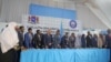 Newly sworn-in legislators take the oath during a swearing-in ceremony in Mogadishu's heavily protected airport, April 14, 2022.