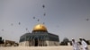 Palestinian Muslims walk in front of the Dome of Rock mosque at the Al-Aqsa mosque compound in Jerusalem's Old City, Apr. 17, 2022. 