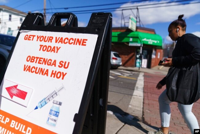 FILE - A sign promoting available COVID-19 vaccines stands outside a vaccination clinic in Providence, R.I., March 3, 2022.