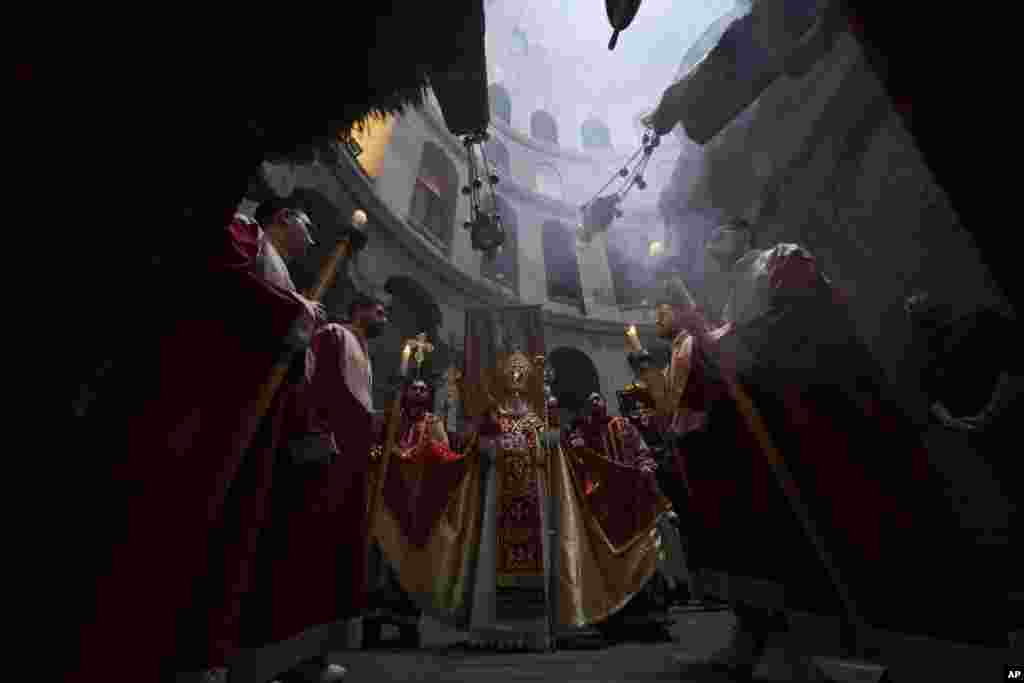 Orthodox Christian clergy mark Palm Sunday at the Church of the Holy Sepulchre, a place where Christians believe Jesus Christ was crucified, buried and resurrected, in Jerusalem.