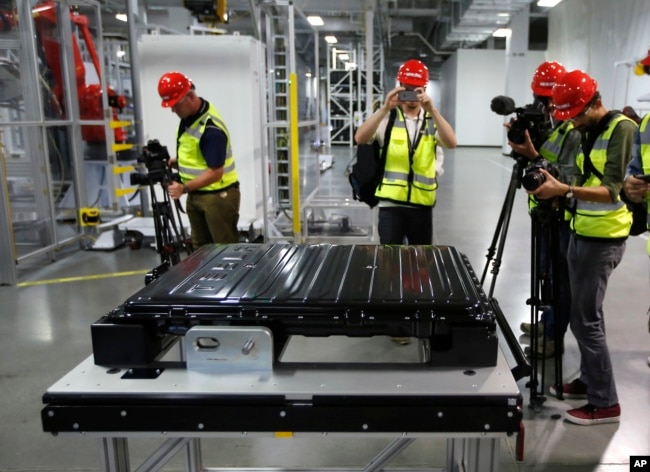 FILE - A Tesla battery pack is displayed during a media tour of the new Tesla Motors Inc., Gigafactory Tuesday, July 26, 2016, in Sparks, Nevada. (AP Photo/Rich Pedroncelli, File)