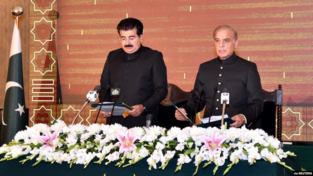 FILE - Shehbaz Sharif takes the oath as the 23rd prime minister of Pakistan from Muhammad Sadiq Sanjrani, chairman of the Senate of Pakistan, at the president's office in Islamabad, April 11, 2022.