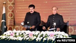 FILE - Shehbaz Sharif takes the oath as the 23rd prime minister of Pakistan from Muhammad Sadiq Sanjrani, chairman of the Senate of Pakistan, at the president's office in Islamabad, April 11, 2022.