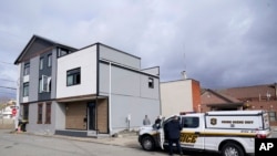 The Pittsburgh Police crime scene unit works the area outside the short-term rental property, left, where police say a shooting took place at a house party in Pittsburgh early Sunday morning, Apr. 17, 2022. 