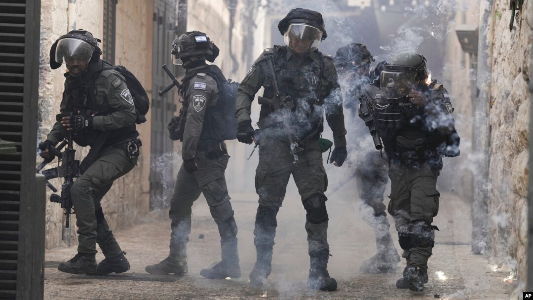 Palestinians shoot fireworks at Israeli police in the Old City of Jerusalem, April 17, 2022. 